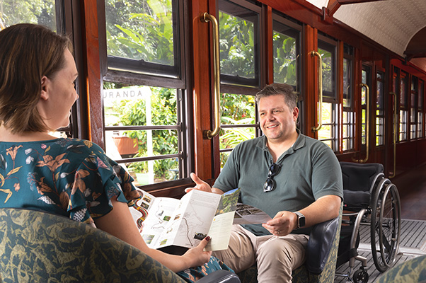 Customers sitting in the accessible carriage of Kuranda Scenic Railway.