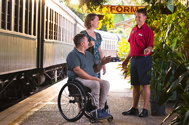 A team member provides assistance to customers at Kuranda Station.