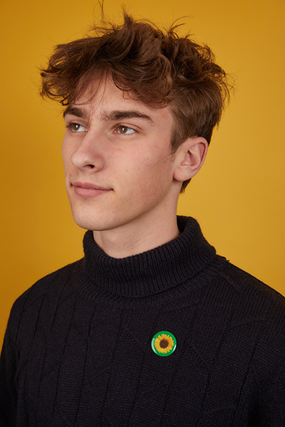 a person wearing the Sunflower Initiative badge